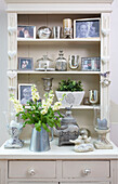 Family photographs and kitchenware on dresser in Staplehurst home Kent England UK