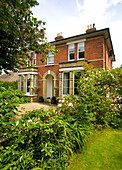 Gravel driveway and front garden of detached brick Staplehurst home Kent England UK