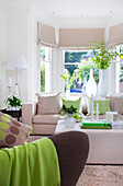 Cream sofa with ottoman in bay window of Wandsworth home London England UK