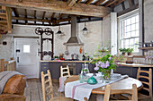Arts and crafts table and chairs in open plan kitchen of Grade ll listed windmill conversion Kent UK