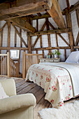 Double bed and timber beams in Grade ll listed windmill conversion Kent UK