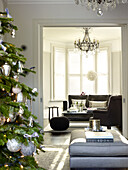 London home England UKChristmas tree in double living room with grey furniture in London home England UK