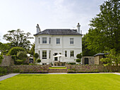 White detached east Sussex home set in lawned grounds England UK