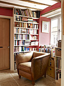 Brown leather sofa and bookcase in Nottinghamshire home England UK