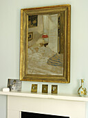 Gilt framed artwork above mantlepiece in Nottinghamshire home England UK