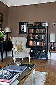 Armchair and bookcase in corner of living room in Hove home East Sussex UK