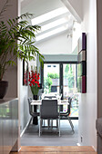 View through hallway yo grey dining suite below skylight windows in contemporary London home, England, UK