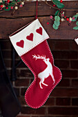 Christmas stocking hangs above fireplace in Kent home, England, UK