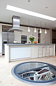 Underfloor storage solution in contemporary London kitchen, UK