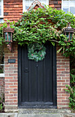 Christmas garland on entrance gate of Sussex home UK