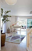 Grand piano and potted olive tree in spacious living room, holiday villa, Republic of Turkey