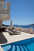 Sunloungers on poolside of luxury holiday villa, Republic of Turkey