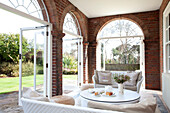 Arched brickwork doorways in garden room of Suffolk home UK