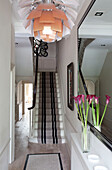 Geblümter Deckenlampenschirm im Flur eines modernen Londoner Hauses mit Teppichboden im Treppenhaus, UK