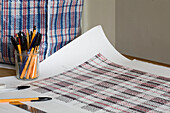 Jar of pens and paper with checked pattern in Rye home, East Sussex, England, UK