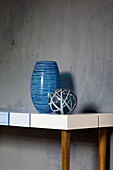 Two blue glassware vases on table in muted London home, England, UK
