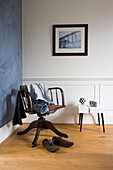 Mens clothes on antique wooden office chair in London home, England, UK
