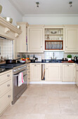 Cream fitted units and stainless steel oven in contemporary London townhouse, England, UK