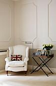 White armchair with union jack cushion in panelled corner of classic Tyne & Wear home, England, UK