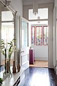 Open door to hallway with mirror and stained glass, Hove, East Sussex, England, UK