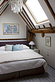 Chandelier above bed in attic conversion Sussex