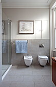 Wall mounted bidet and toilet in bathroom of contemporary London townhouse, England, UK
