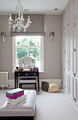 Table and mirror at dressing room window of classic London home, UK