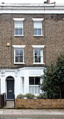 Three storey brick facade of London townhouse, England, UK