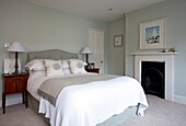 Pastel green classic bedroom in London townhouse, England, UK