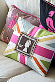 Union Jack cushion with postage stamp on sofa in Sussex home, England, UK