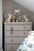 Ornaments on painted chest of drawers in attic bedroom of Dorset cottage, England, UK