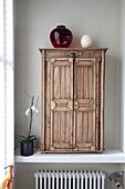 Antique Victorian wooden medicine chest on recessed shelf in bathroom of London townhouse, England, UK