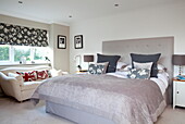 Co-ordinated cushions and blinds in Staffordshire farmhouse bedroom England UK