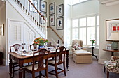 Wooden dining table in open plan room of Kent family home England UK