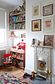 Toy storage and artwork in child's room of Kent family home England UK