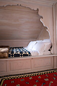 Recessed bed with carved wooden alcove in mountain chalet in Chateau-d'Oex, Vaud, Switzerland