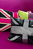 Union Jack cushions on pink sofa in contemporary SW London home, England, UK