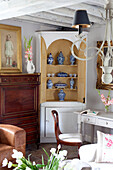 Blue and white chinaware in corner cabinet of West Sussex home England UK