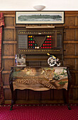 Pool ball cabinet above upcycled sideboard in games room of London home, UK