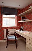 Wooden chair at cream desk with laptop in London townhouse, England, UK