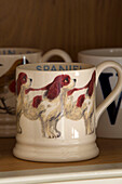 Spaniel mug on shelf in Suffolk farmhouse kitchen,  England,  UK