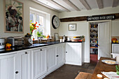 White fitted country style kitchen diner with view through to Pantry in London home  England  UK