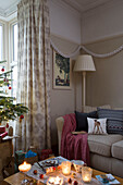 Lit candles on coffee table in corner of room in Dronfield home  Derbyshire  England  UK