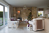 Christmas tree in stone recess with white sofas in Laughton living room  Sheffield  UK