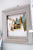 Greeting cards pegged to string in picture frame Norfolk home England UK