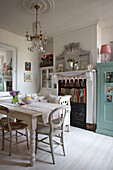 Glass chandelier above dining table in Norfolk home England UK