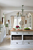 Basket storage and cornucopia on kitchen island in Dorset home England UK