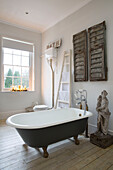 Freestanding bath with architectural salvage in Surrey home England UK