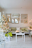 Künstlicher Weihnachtsbaum mit Spiegelsammlung in weißem Wohnzimmer im Süden Londons, England UK