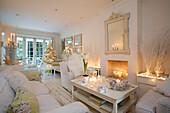 Candlelit double living room at Christmas in South London family home England UK